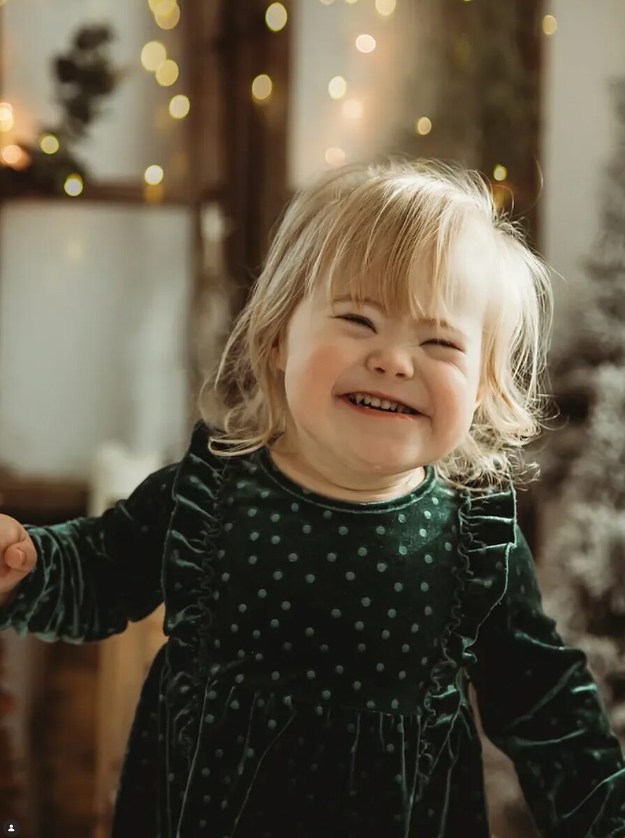 Weihnachts-Mini – lachendes Kleinkind im grünen Samtkleid